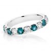 Half circle shared claw band of teal blue tourmalines alternating with round brilliant cut diamonds in white gold