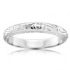 Half rounded white gold band with engraved pattern and millegrained edges