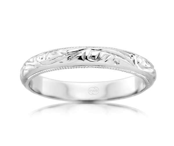 Half rounded white gold band with engraved pattern and millegrained edges