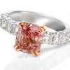 18ct white gold claw set diamond band ring with a rose gold double claw setting featuring a cushion cut Padparadscha Sapphire