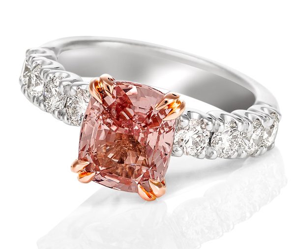 18ct white gold claw set diamond band ring with a rose gold double claw setting featuring a cushion cut Padparadscha Sapphire