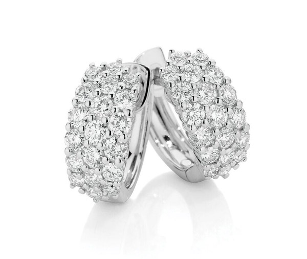 huggie style earrings featuring three rows of claw set round brilliant cut diamonds