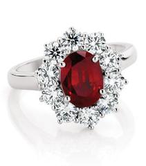 red coloured gem and diamond halo engagement ring